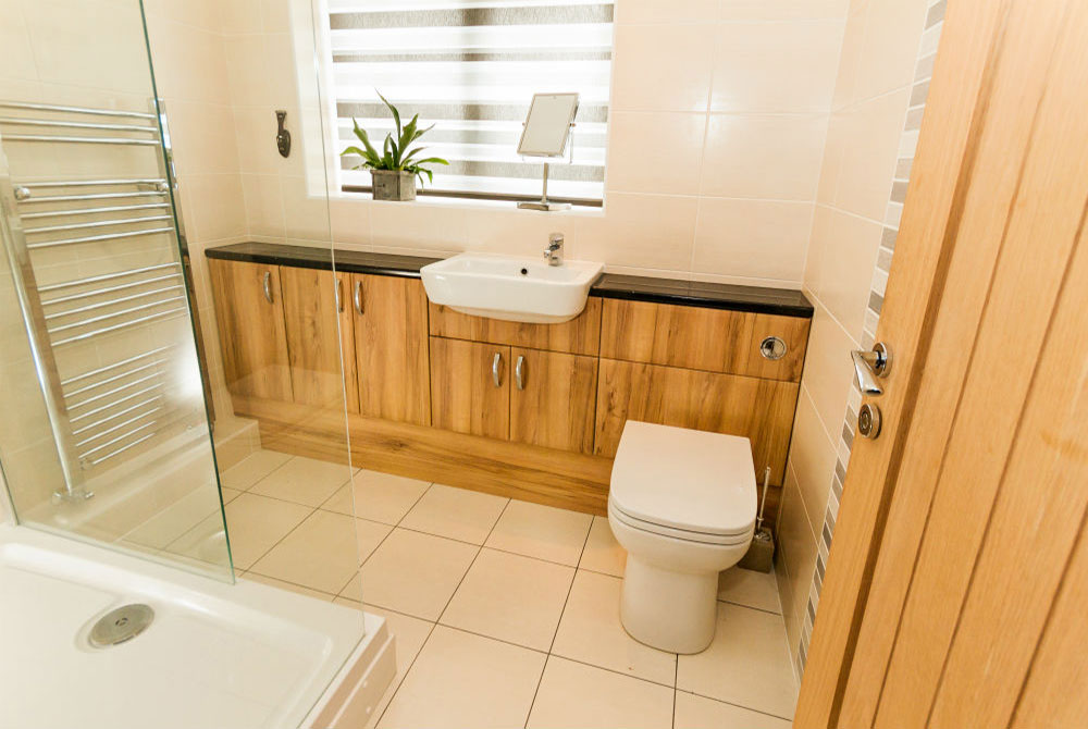 Image of a toilet, basin and cabinets